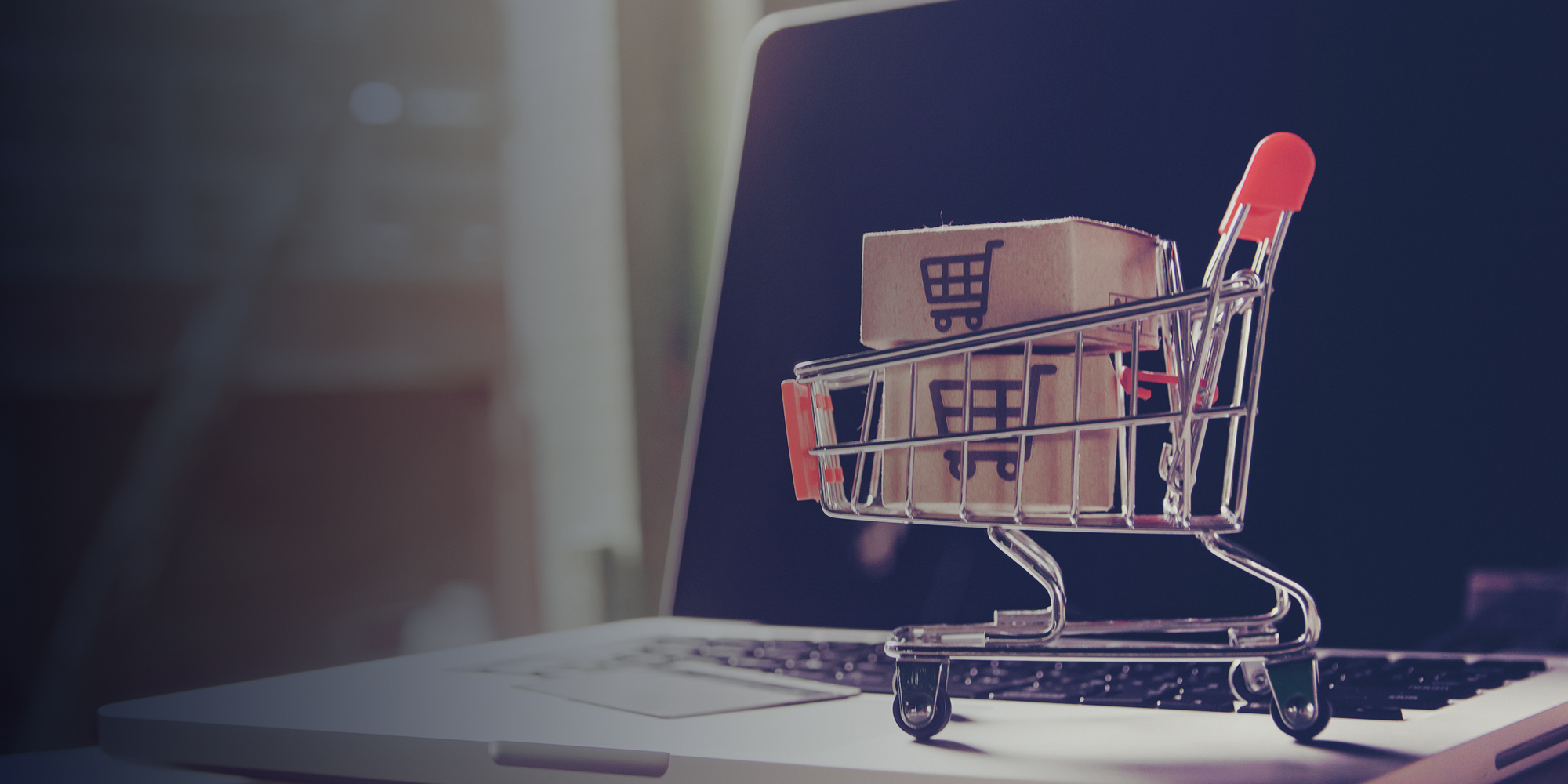 SEO, a small shopping trolley on a laptop keyboard