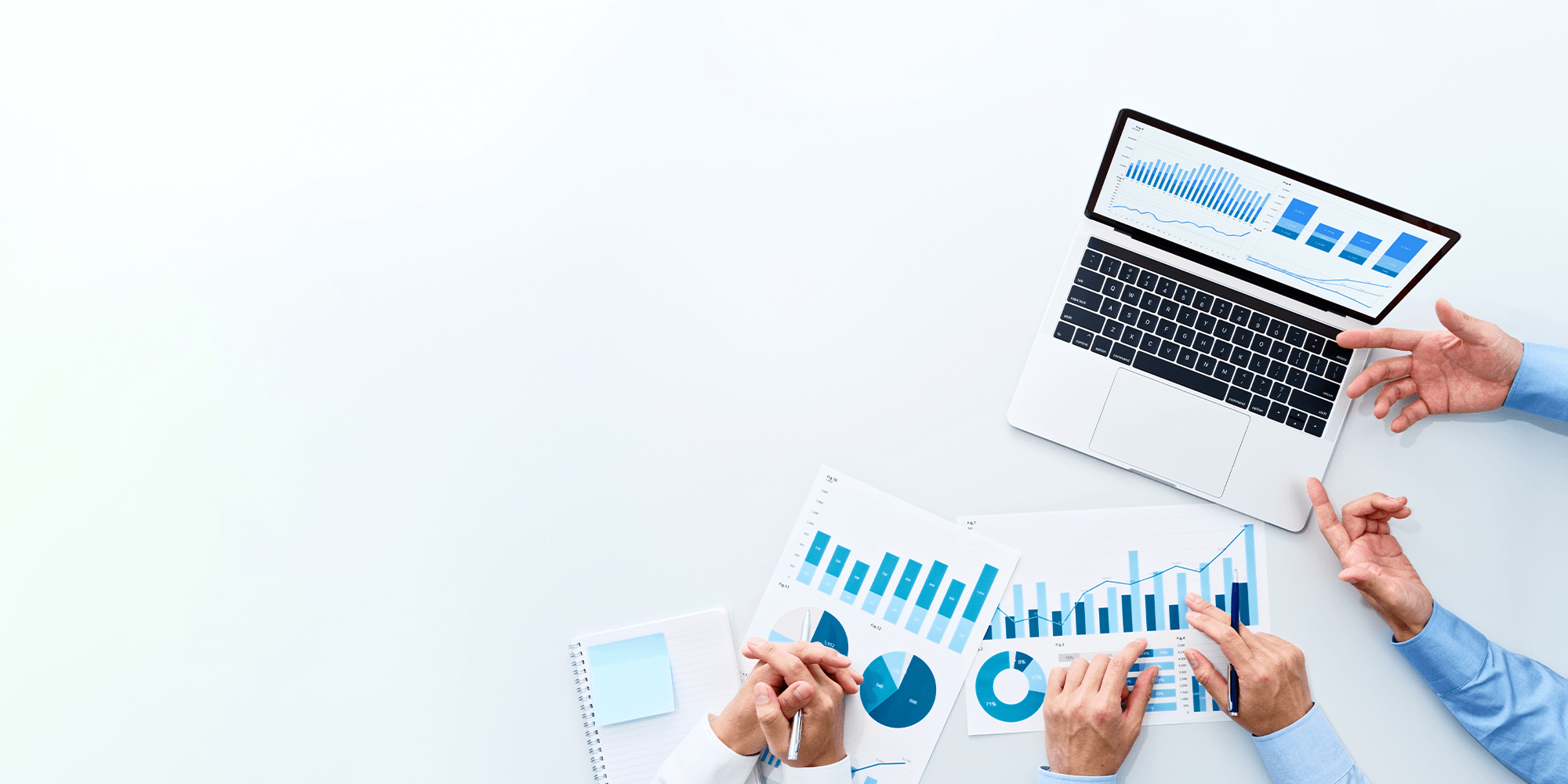 SEO, close up of the hands of three people pointing at a laptop displaying SEO graphs